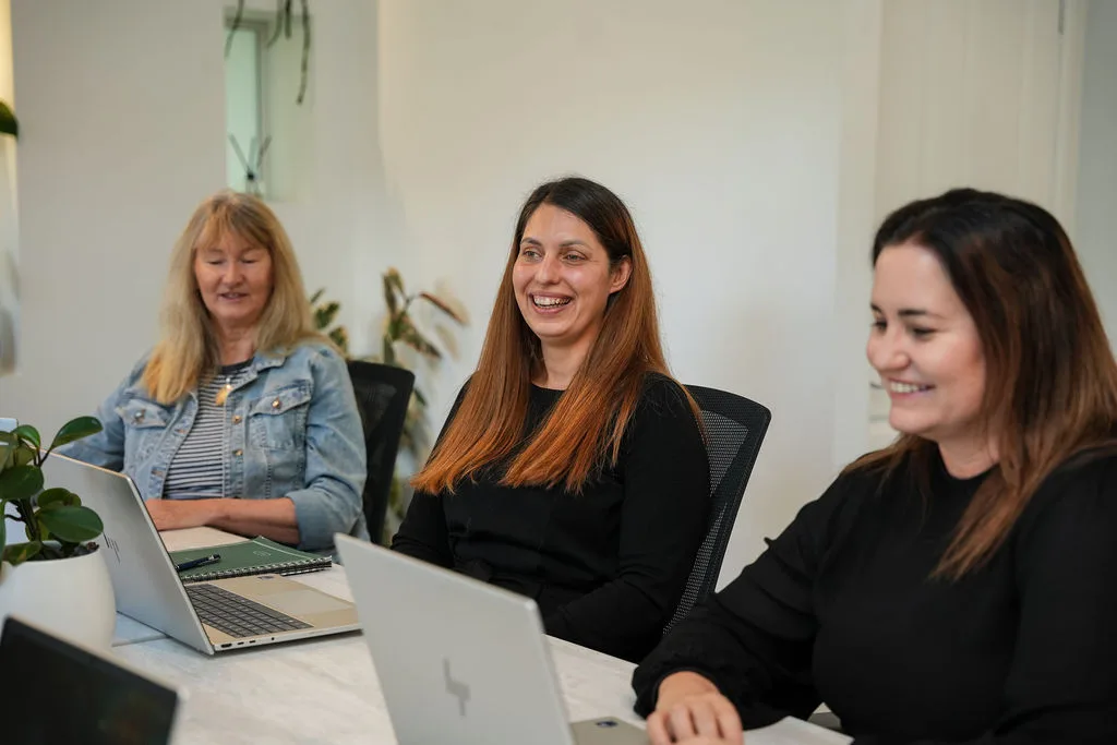 A business owner laughing with KGA directors Lize Van Schalkwyk and Jen Smith